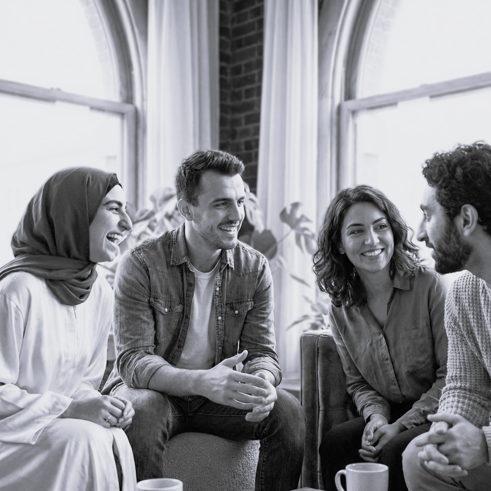 Muslim woman in hijab laughing with colleagues